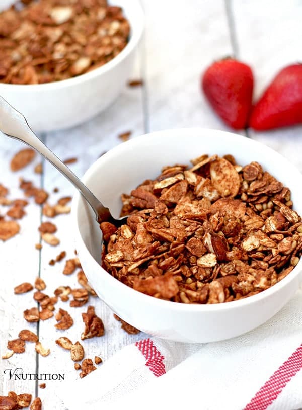 chocolate granola in white dish with spoon