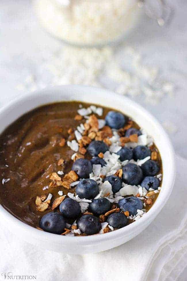 Vegan Chocolate Smoothie Bowl on a white table with a sprinkling of shredded coconut