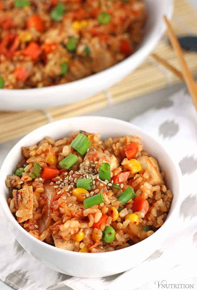 small bowl of vegan kimchi Fried Rice on a grey and white patterned napkin. 