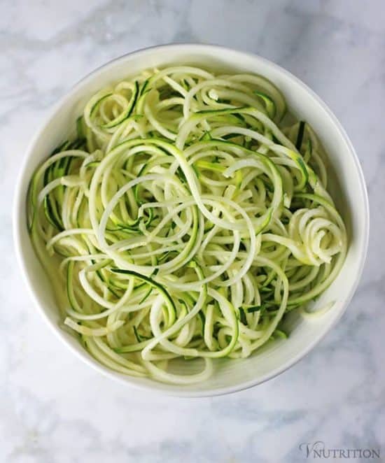 overhead shot of spiralized zucchini noodles in white bowl