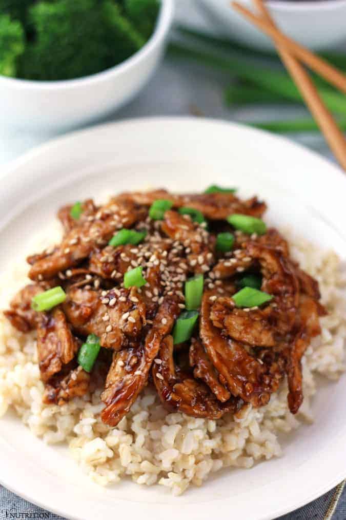 Mongolian Soy Curls on a bed of brown rice and topped with green onions and sesame seeds