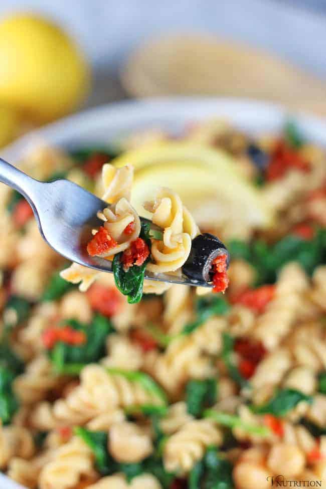  bite of vegan Pasta Salad and veggies on a fork.