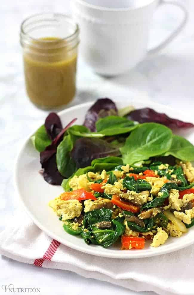Simple Tofu Scramble with mixed veggies on a white plate with a white and red napkin