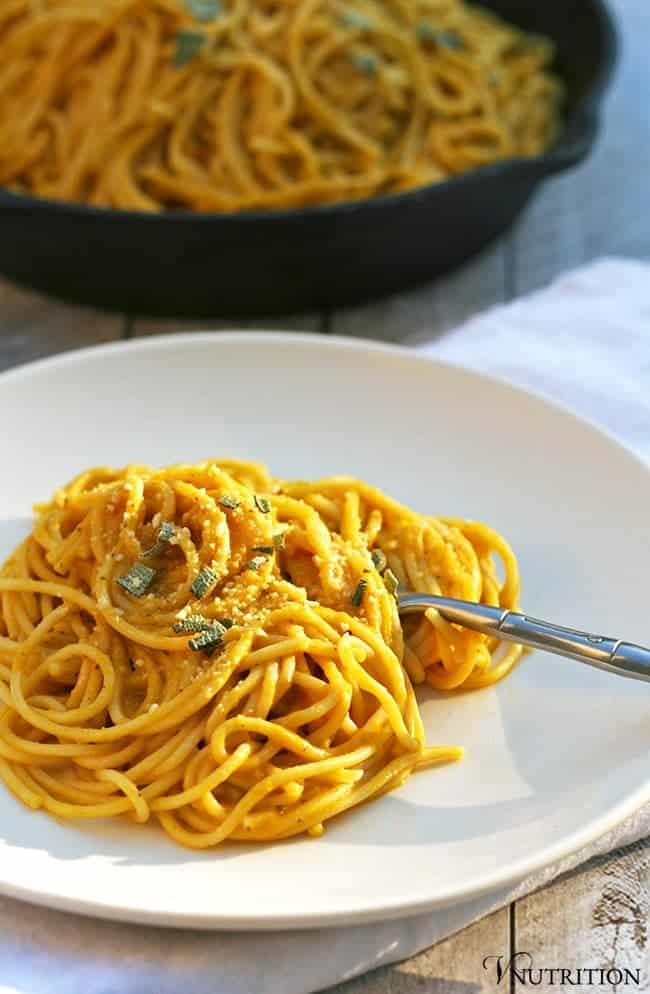 Vegan Pumpkin Pasta on a white pasta bowl with a silver fork.