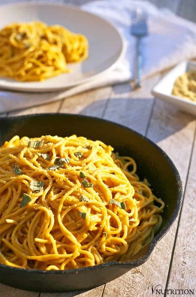 cast iron skillet filled with Vegan Pumpkin Pasta on a table in the sunshine.