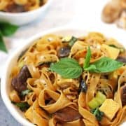 Thai basil noodles in white bowl.