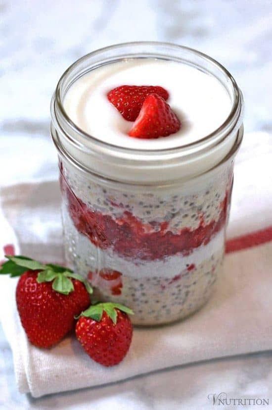 Vegan Strawberries and Cream chia Overnight Oats in a small mason jar topped with fresh strawberries. 