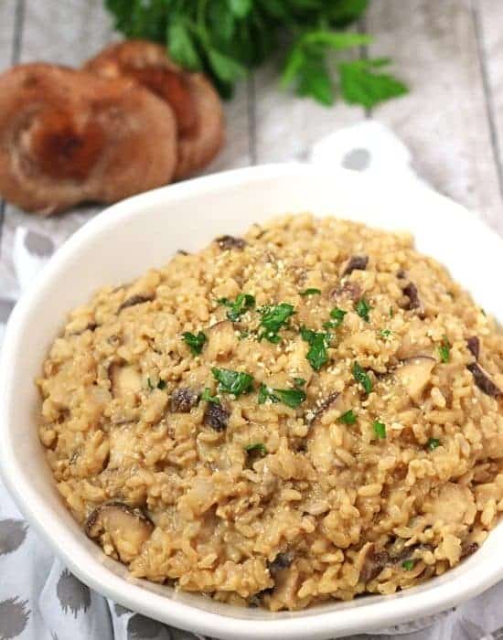 mushroom risotto with mushrooms and cilantro in background