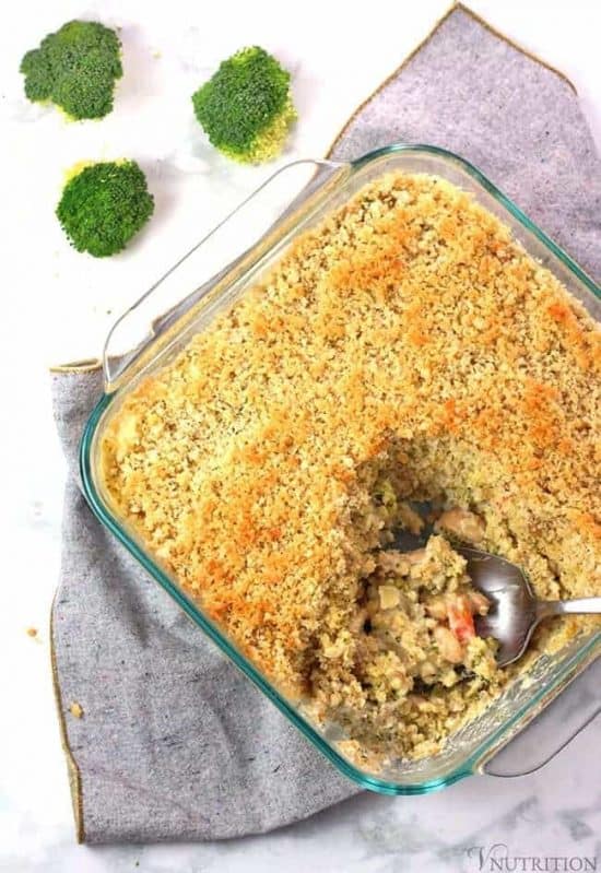 overhead shot of Vegetable Bean Casserole on gray napkin with spoon and broccoli