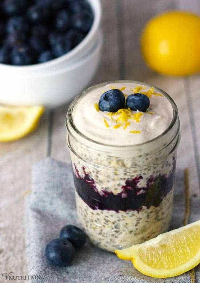 Blueberry Lemon Cheesecake Overnight Oats | These Blueberry Lemon Cheesecake Overnight Oats are tart, sweet, and creamy all at the same time. It's a healthy breakfast recipe you can make ahead of time (meal prep!) for those mornings that you're in a rush! 8 oz mason jar of layered Blueberry Lemon Cheesecake Overnight Oats.