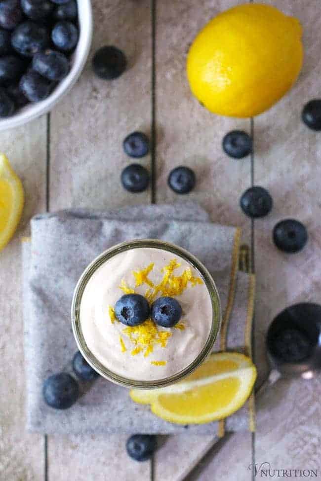 overhead shot of Cheesecake Overnight Oats topped with fresh blueberries and lemon zest.