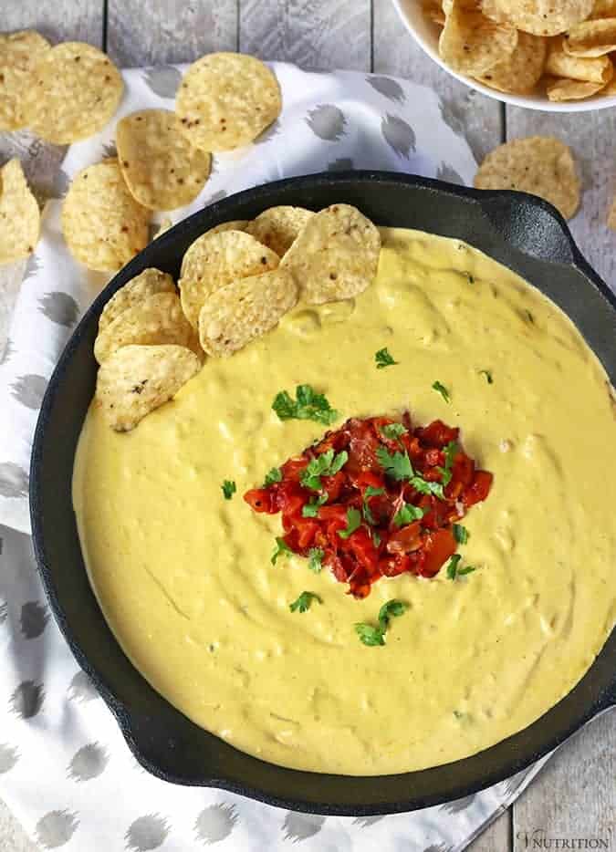 Vegan Cashew queso in a cast iron skillet with tortilla chips.
