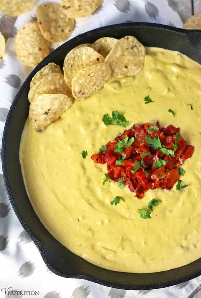 overhead shot of vegan queso dip garnished with extra rotel and cilantro. 