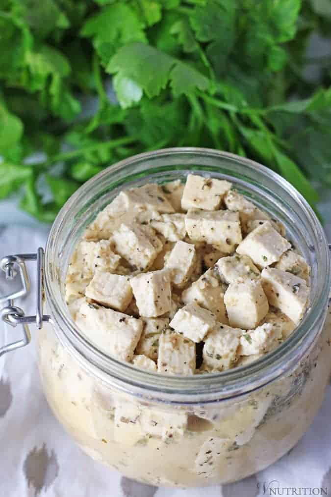 french spring-loaded mason jar filled with vegan tofu feta cheese.