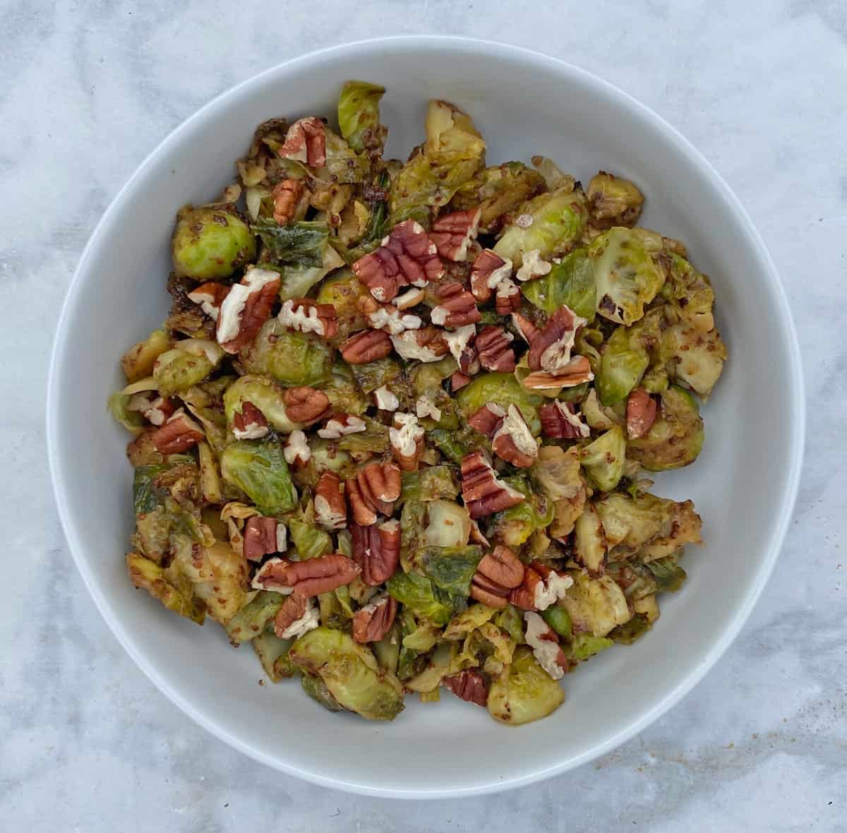 Brussels sprouts in white bowl.