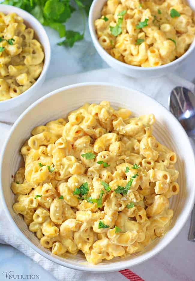 Creamy Vegan Cashew Mac and Cheese in three white bowls.