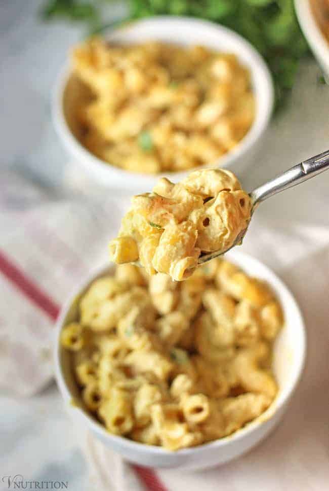 one bite of cashew mac and cheese on a spoon.