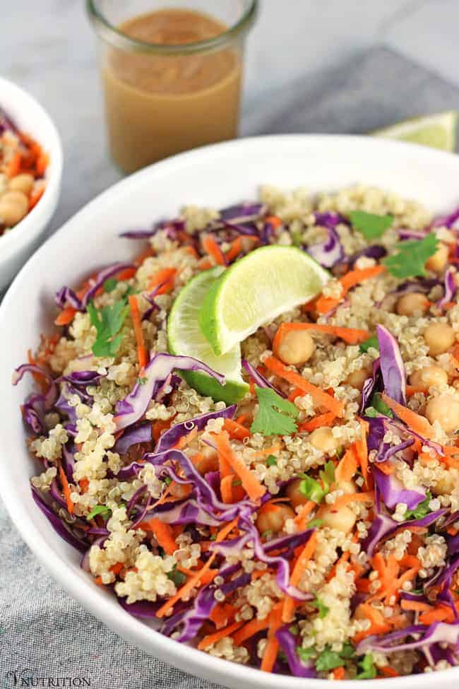 Thai Quinoa Salad garnished with cilantro and limes.