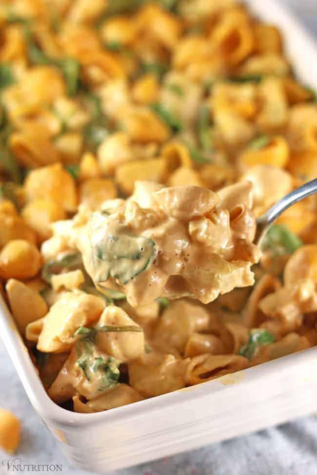 closeup of a spoonful of Buffalo Cauliflower Mac and Cheese being removed from the vegan casserole.