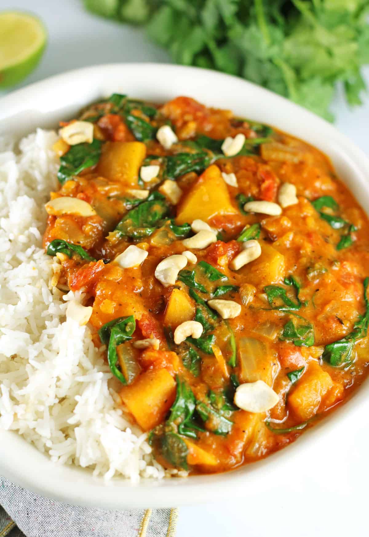 vegan butternut squash curry with cashews on top.