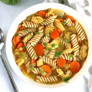 vegan chicken noodle soup in a white bowl