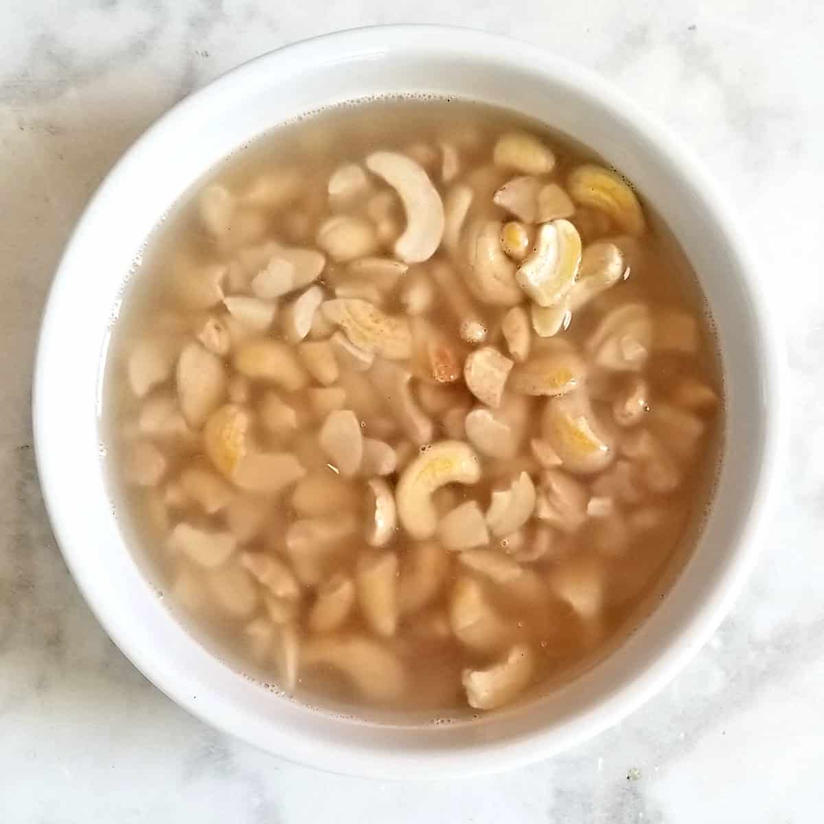 cashews soaking in water for vegan cheese sauce recipe.