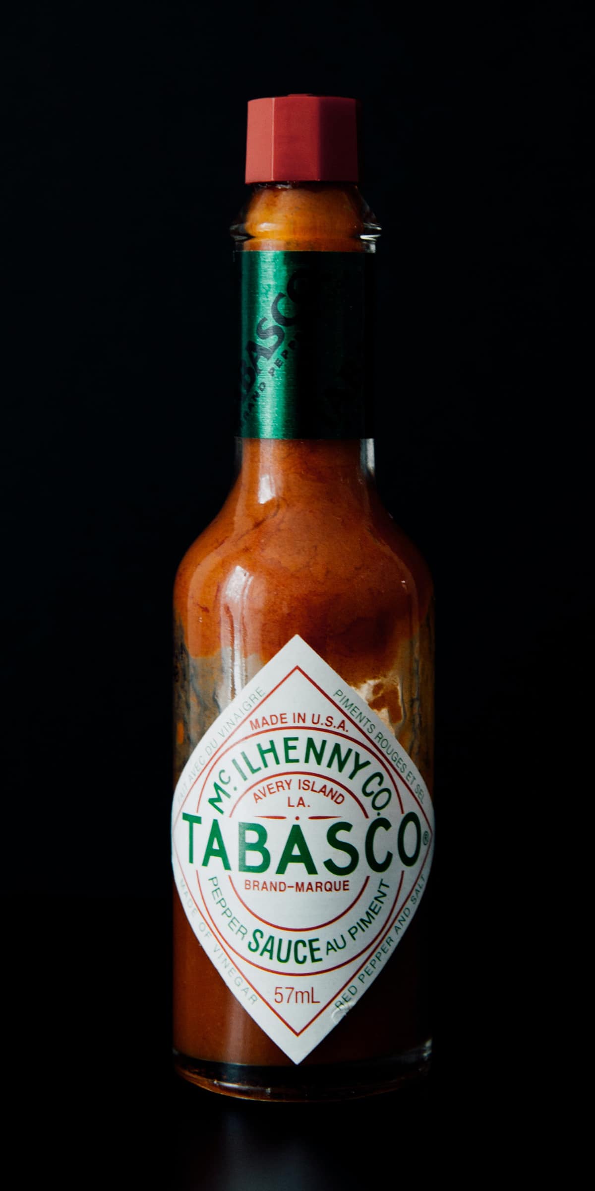 bottle of tabasco sauce with dark background