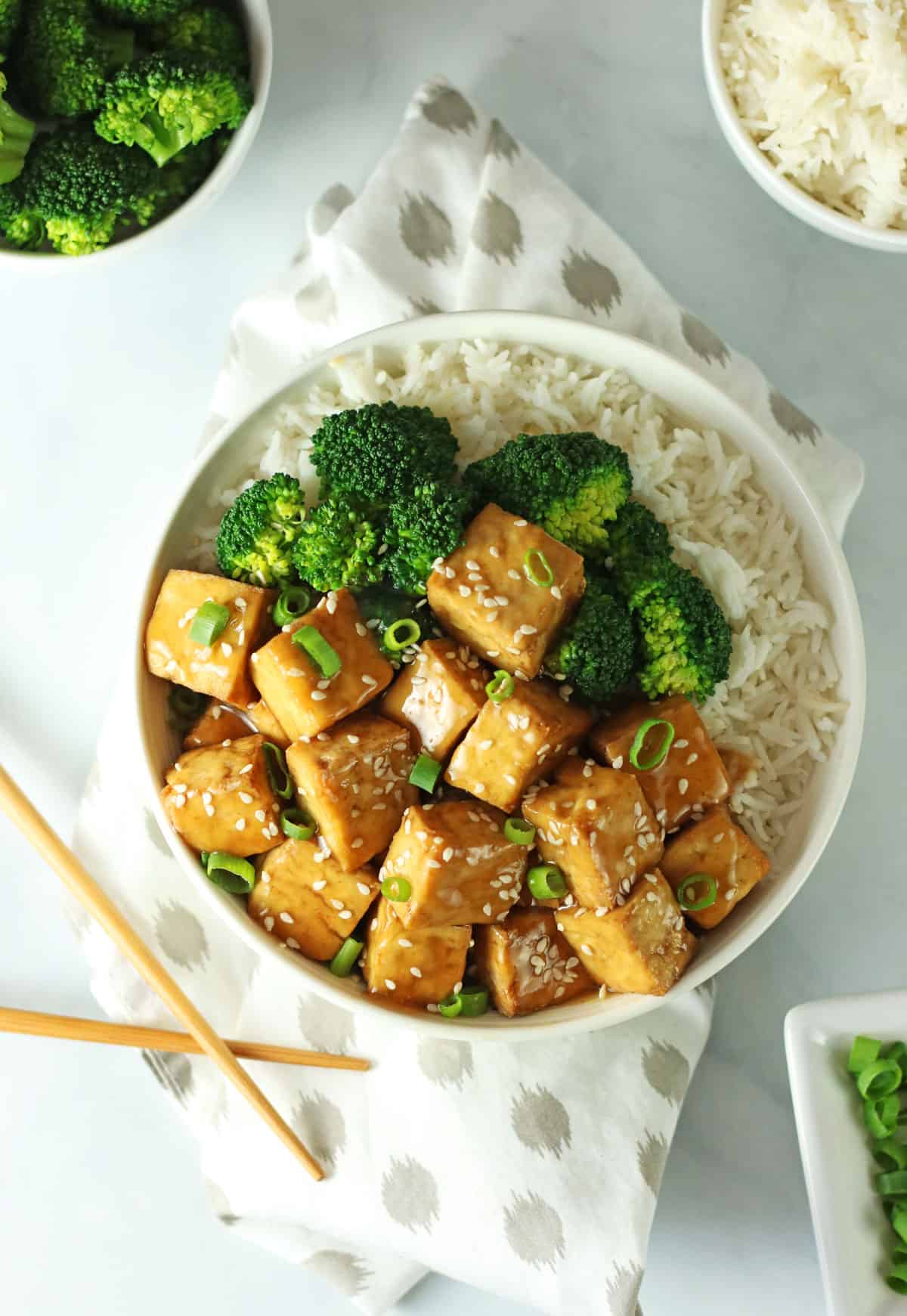 overhead shot of a crispy baked vegan teriyaki tofu bowl with broccoli.