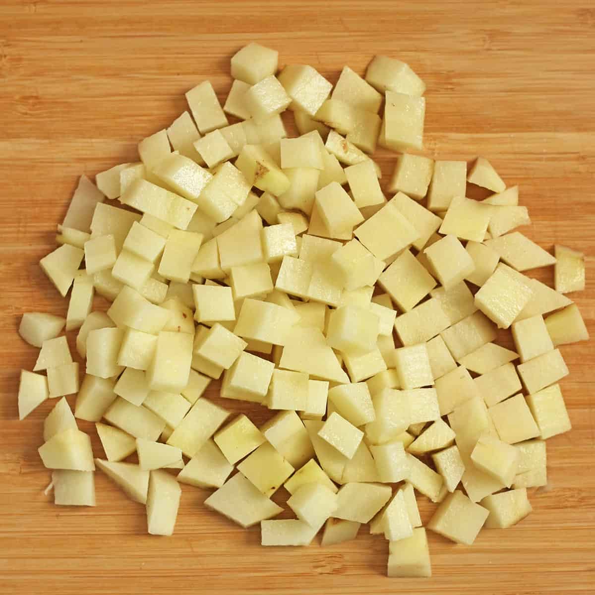 chopped potatoes on wooden cutting board