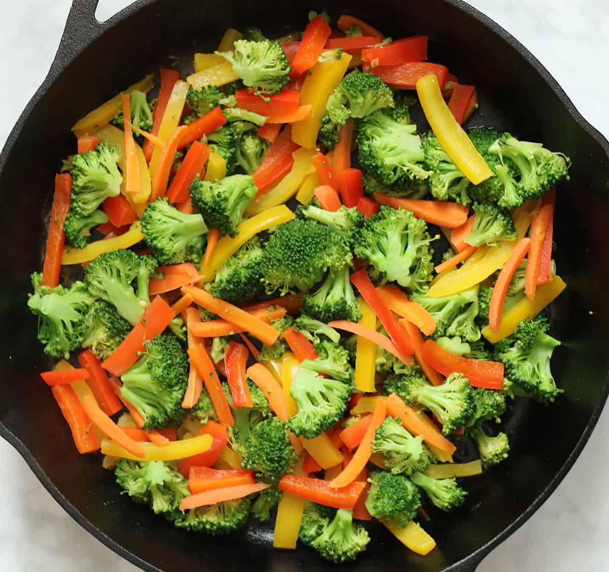 cooked broccoli, carrots, and peppers added to tempeh to stir fry.