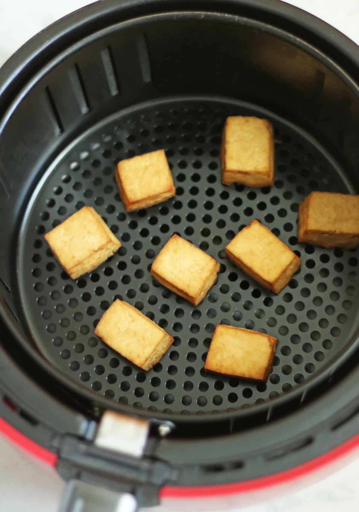 tofu being air-fried till crispy.