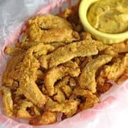 vegan chicken strips in a basket with dipping sauce