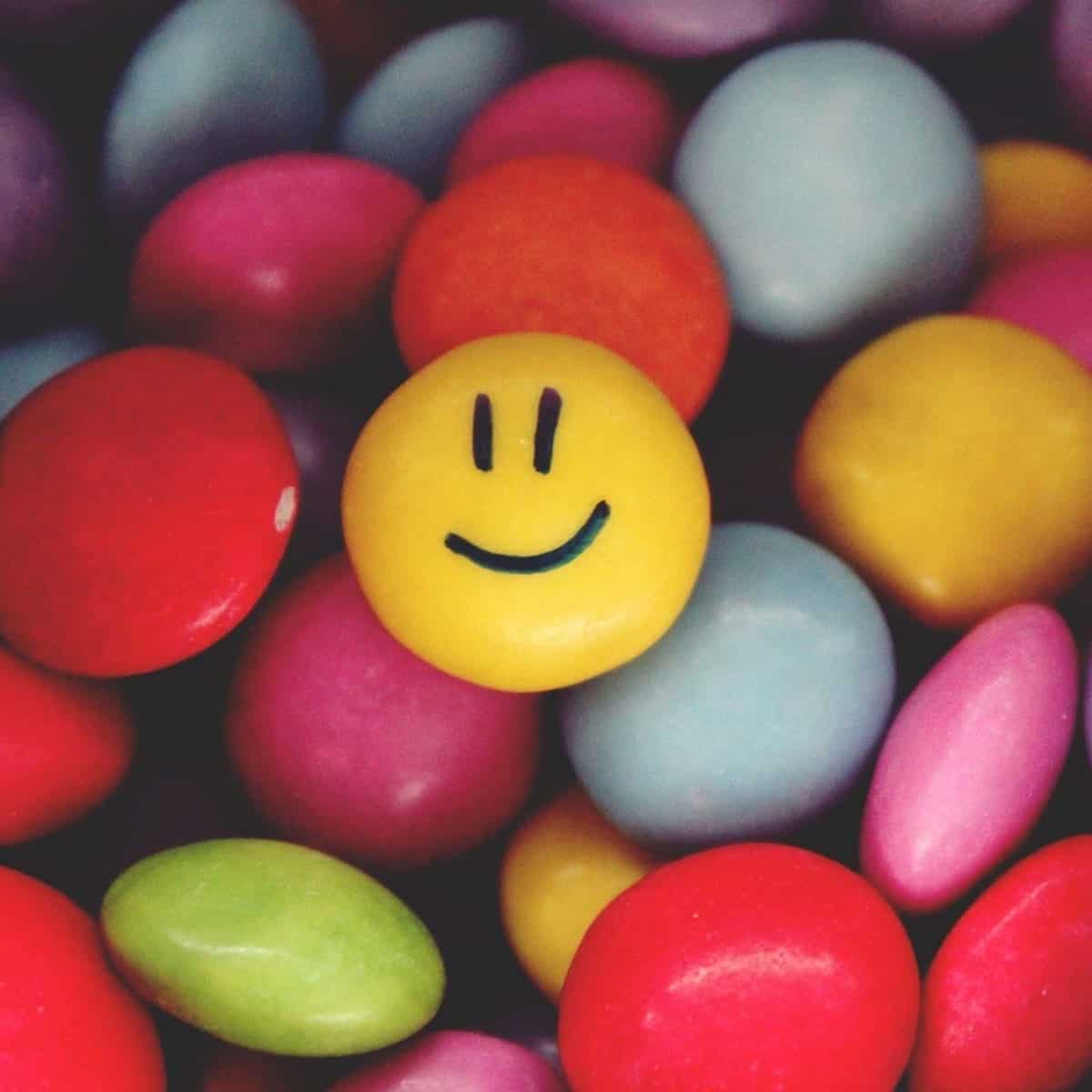 colorful round candy with smiley face on one