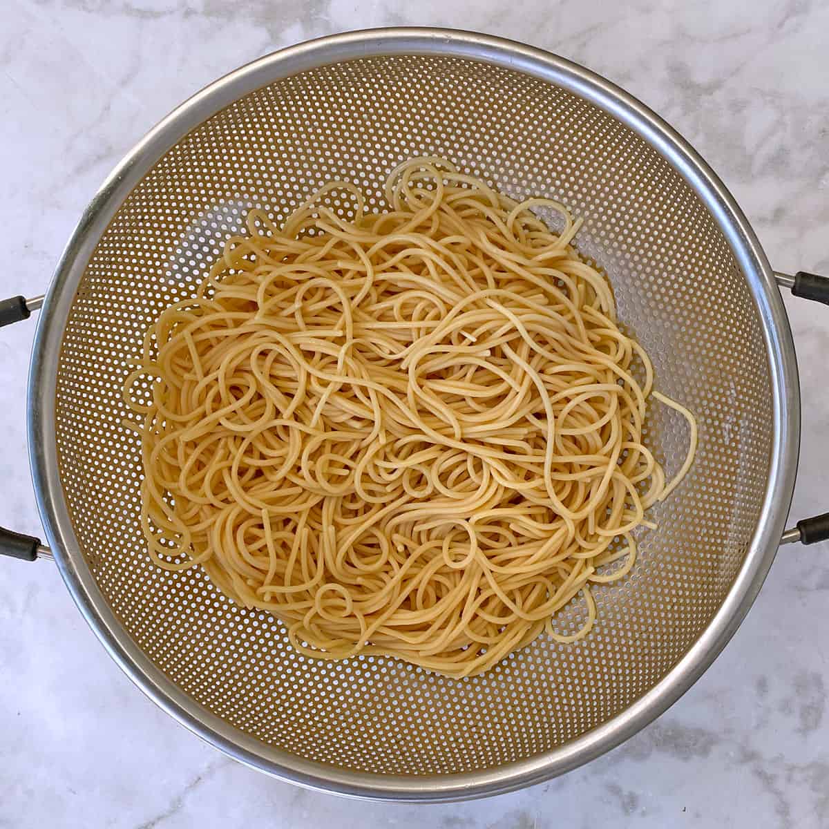 cooked gluten-free ramen noodles in colander.