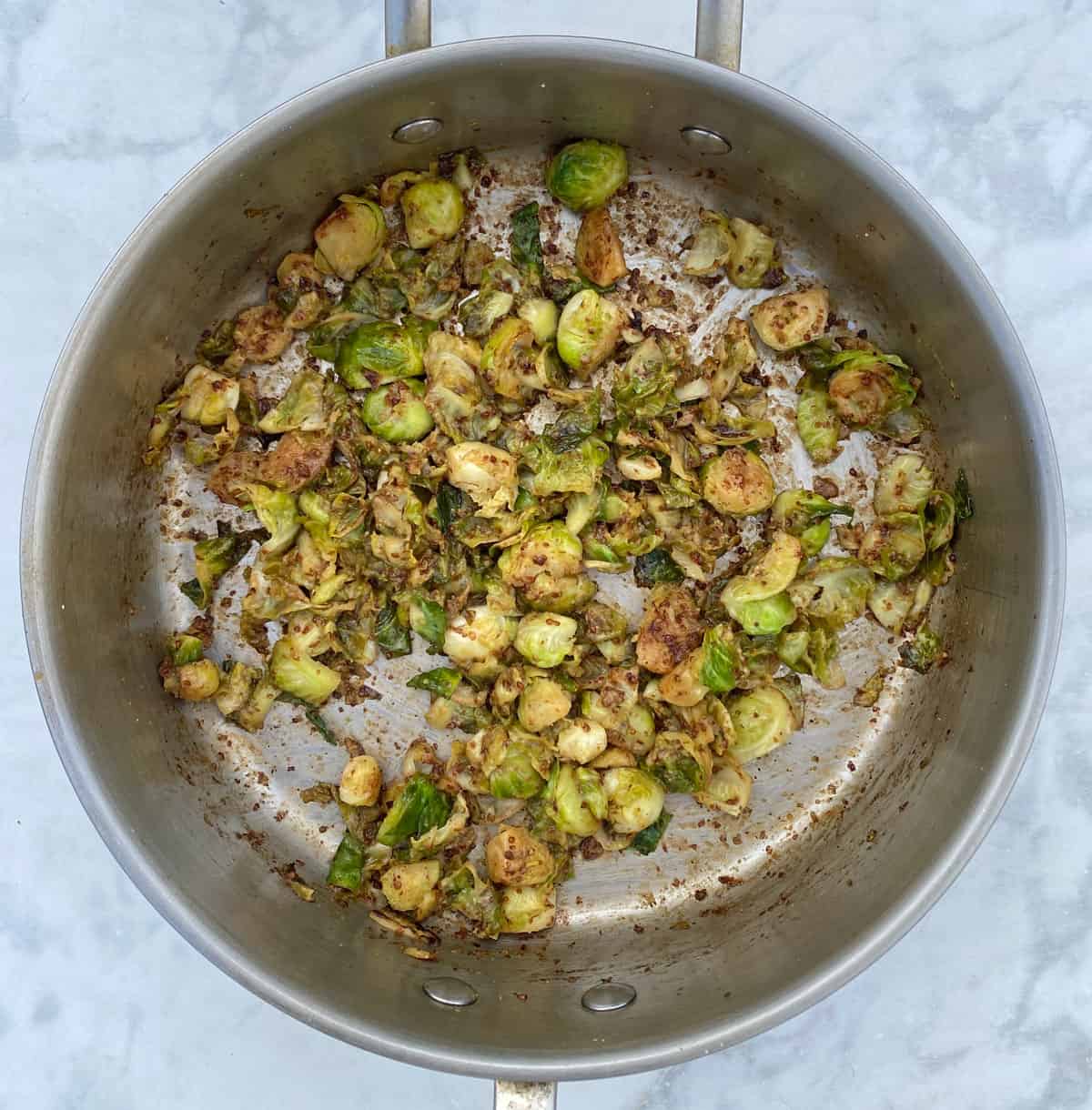 brussels sprouts in pan with maple syrup and dijon.