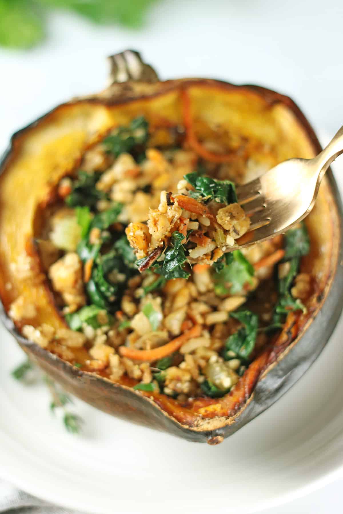 fork holding up some stuffing from acorn squash.