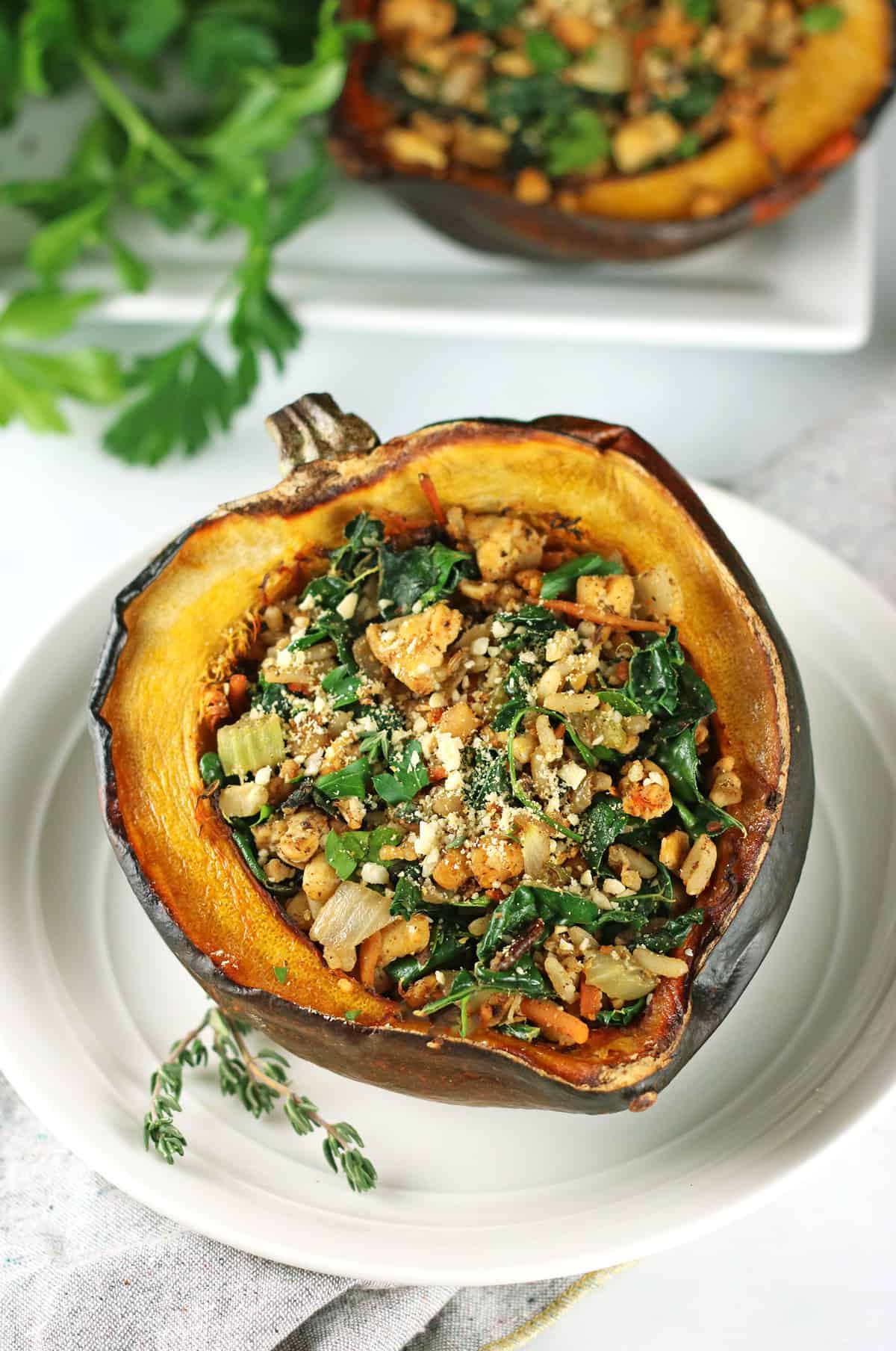 acorn squash on plate with thyme sprigs.