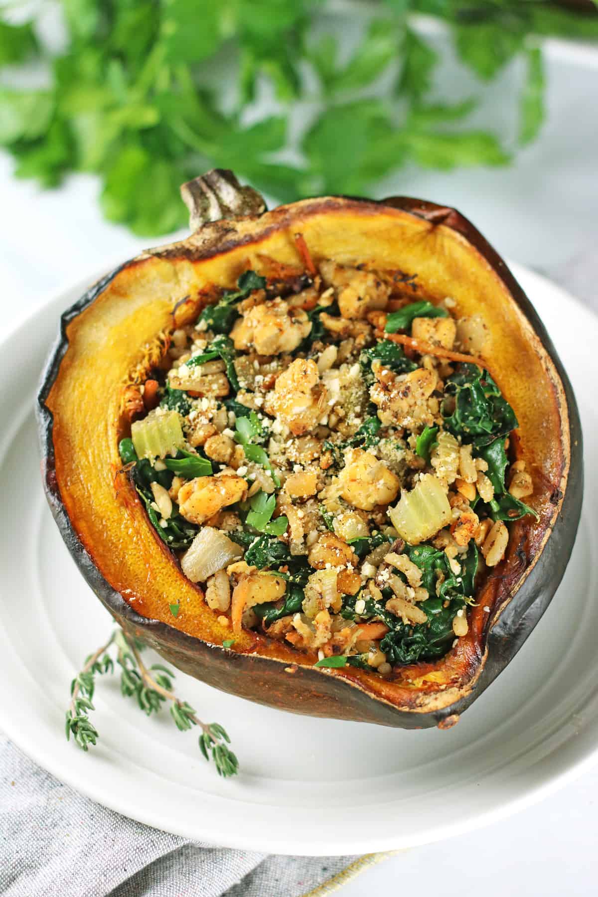 vegan stuffed acorn squash on a white plate.