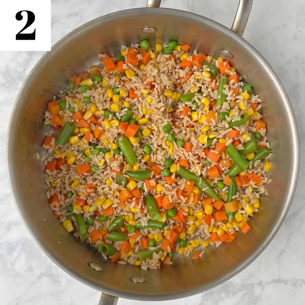 brown rice and vegetables in pan.