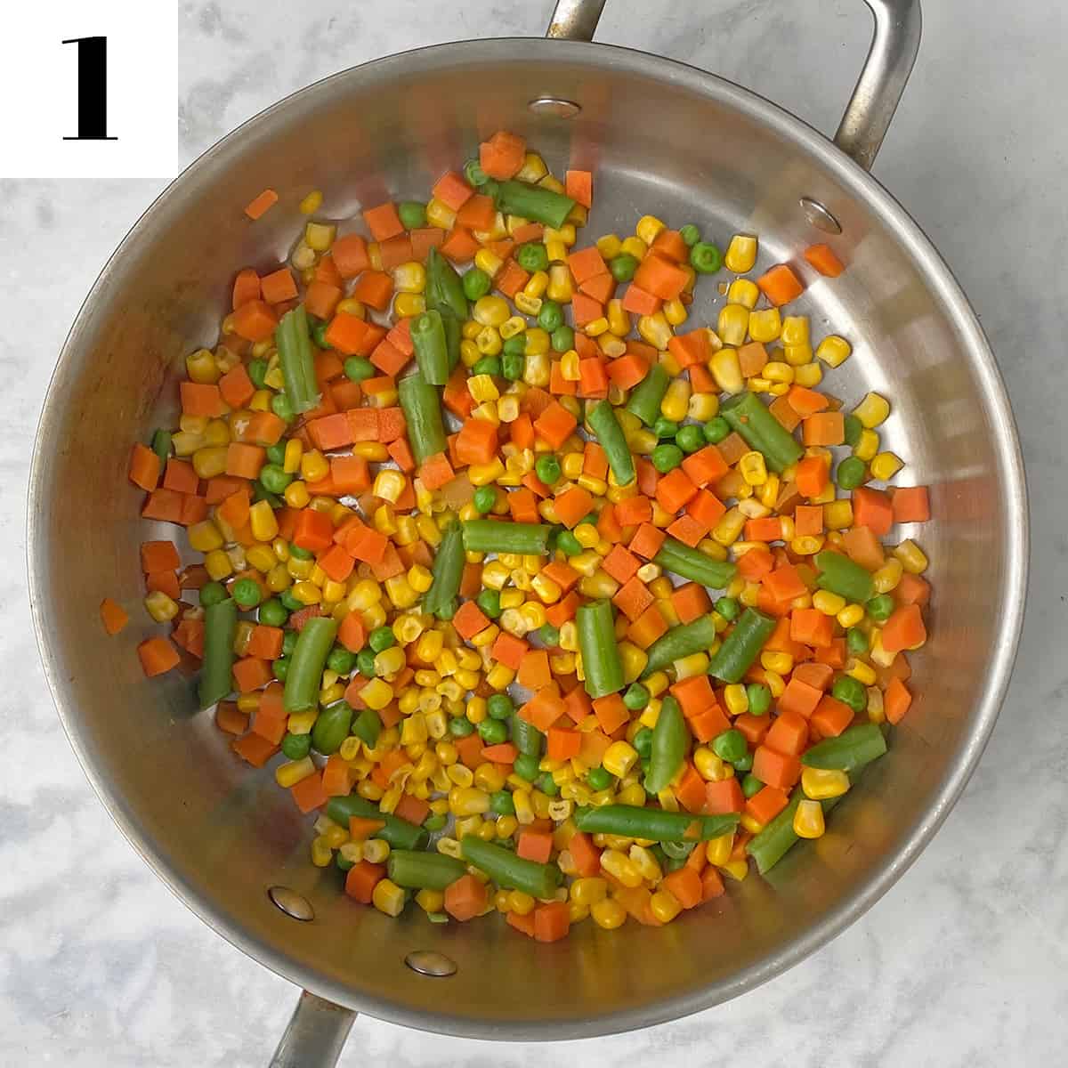 corn, carrots and green beans cooking in pan.