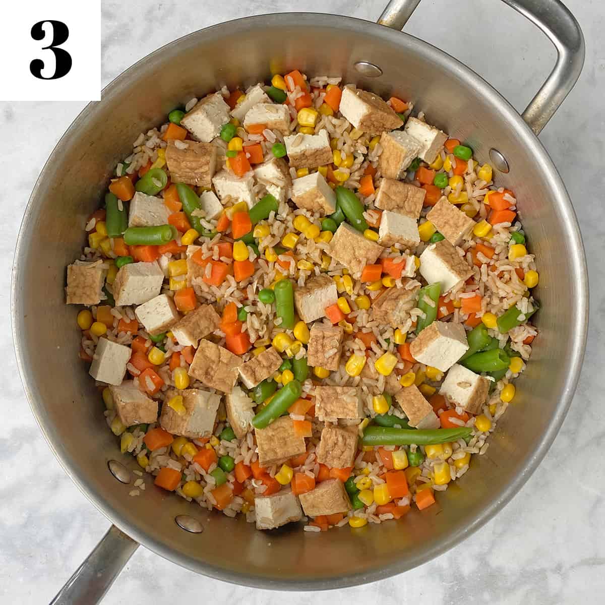 tofu, brown rice, and vegetables in pan.